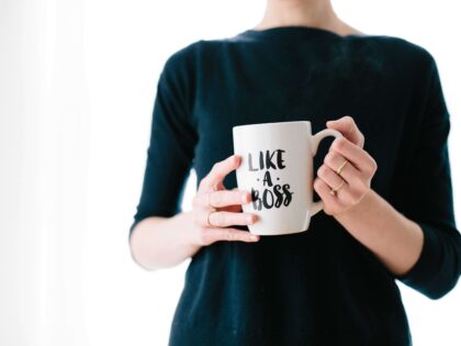 woman holding a cup with a caption "like a boss"