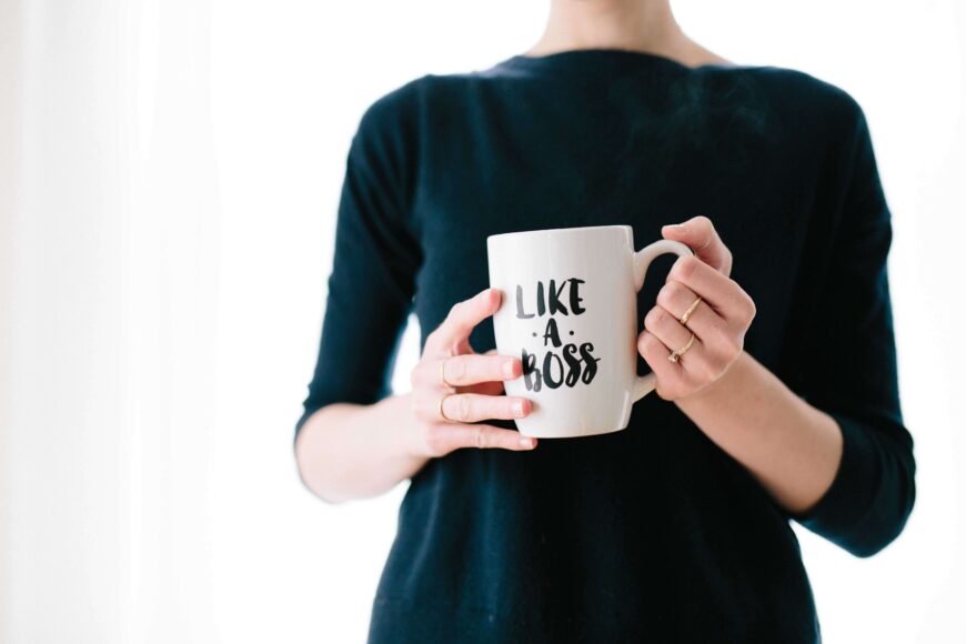 woman holding a cup with a caption "like a boss"